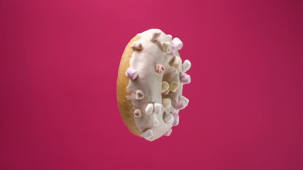 Isolated Donut Rotates on Pink Background. A Beautiful Footage of Sweets for Children and Adults