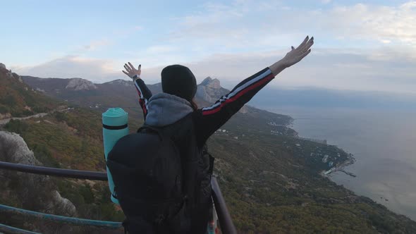 Happy Traveler Girl with a Successful Emotion By Raise Two Arms Over Her Head. Cheering Successful