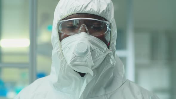 Portrait of African American Scientist in Protective Suit and Mask