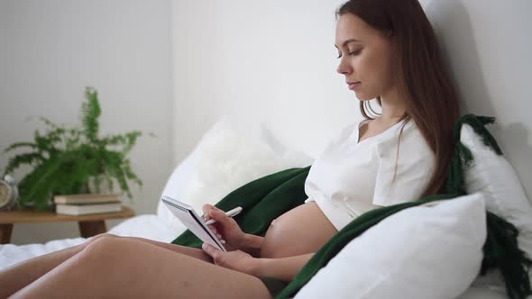 Pregnant Woman Write Diary Sit on Bed Spbd