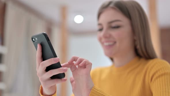 Hands of Beautiful Young Woman Texting on Smartphone