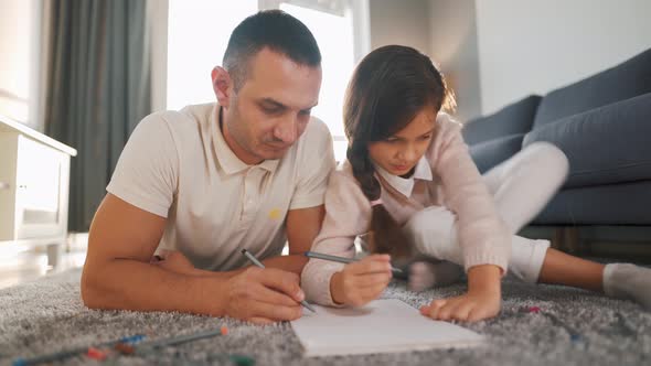 Father and Daughter Are Having Fun and Painting Together. Concept of a Happy Family and Quality