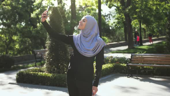 Attractive Muslim Lady in Casual Clothes and Gray Hijab