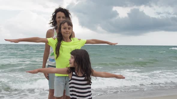 Woman with Children Playing on the Beach