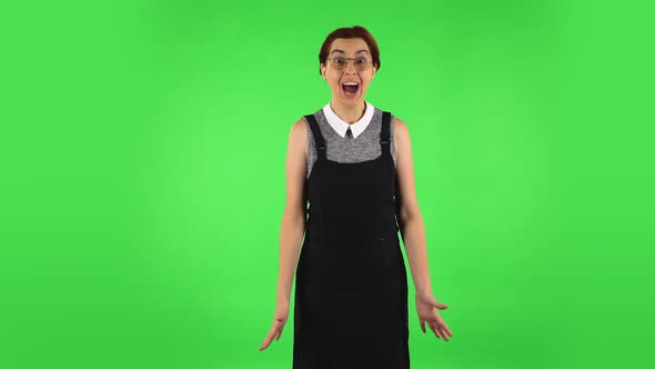 Funny Girl in Round Glasses with Shocked Wow Face Expression and Rejoicing. Green Screen