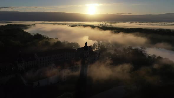 Amazing Dawn in the Foggy Nesvizh Fog Over the River