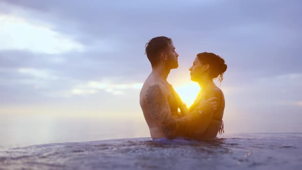 Couple Standing Close at Each Other on an Infinity Pool