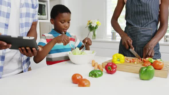 Happy family preparing food in kitchen