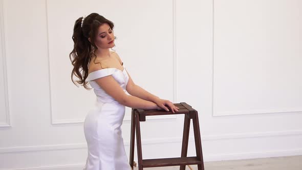 Virgin Model Bride in White Dress Poses for the Photographer