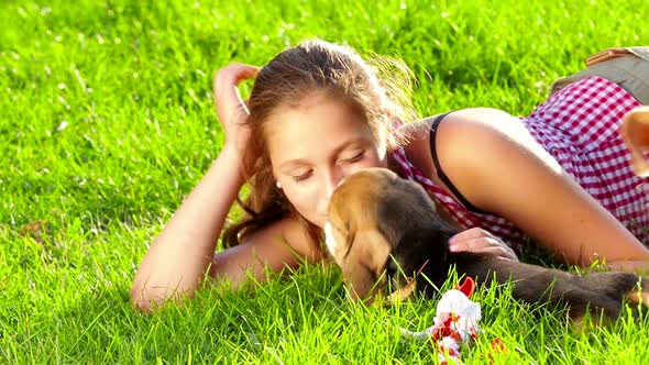 Girl Playing with Her Beagle Dog in Park. Slow Motion