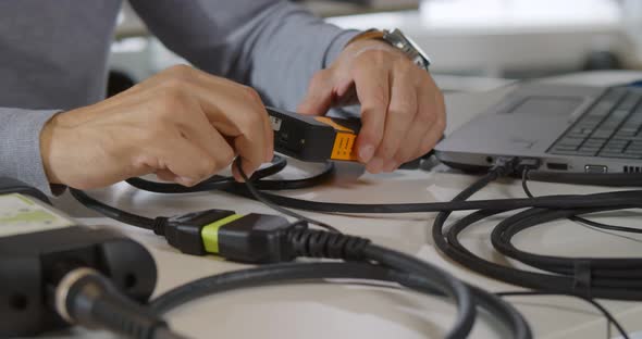 Cropped Shot of Male Itspecialist Connect Wires to Gadget and Fix Laptop