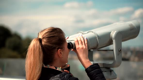 Tourist Female Look In Tower Viewer In New Weekend Trip. Girl Looking Through Binoculars In Town.