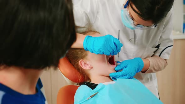 Close Up of Girl Patient Lying on Stomatological Chair with Open Mouth