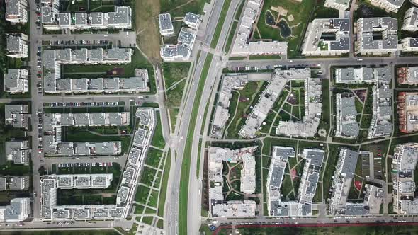 Aerial drone shot flying over residential apartment buildings and commercial property