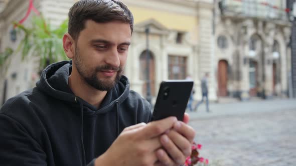 Portrait Business Man Reading Message with Smart Phone in Outdoor Video Calls