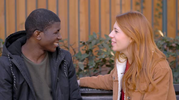 Red haired woman Refusing African American Man Trying To kiss Her