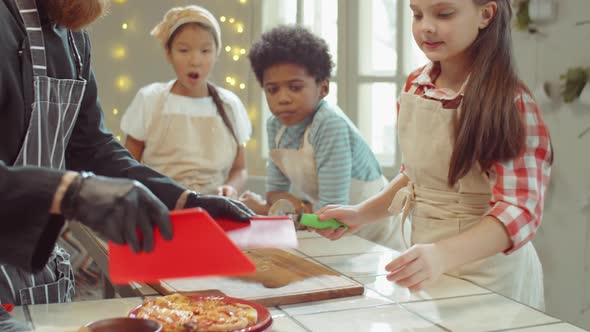 Little Girl Enjoying Pizza Smell on Cooking Masterclass