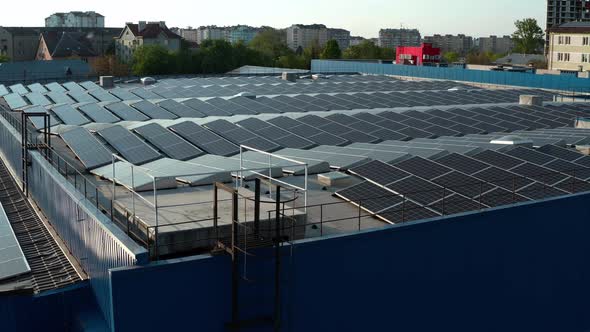 Aerial Drone View. Warehouse with Solar Panelsthe, Sunny Batteries for Receiving Alternative Energy