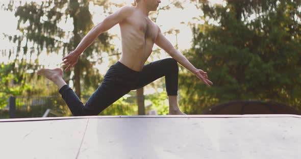 Young Man Practicing Yoga Outdoors