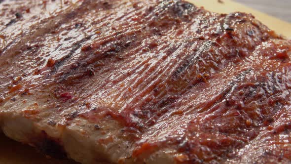 Super Closeup of the Juicy Delicious Ribs Spread with Tomato Sauce