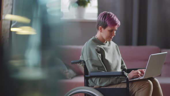 Portrait of Young Disabled Woman with Laptop at Home