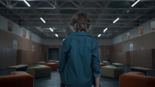 Unknown Teen Schoolboy Walking Empty Hallway