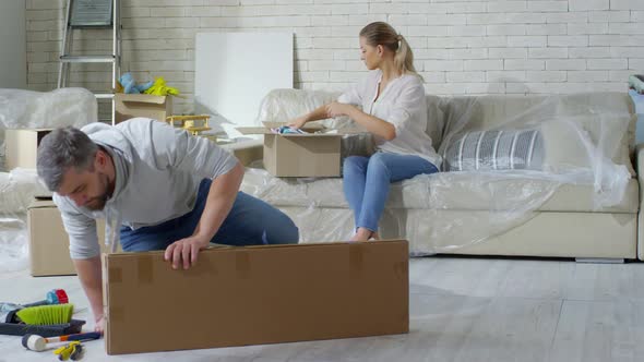 Couple Packing Clothes before Moving alt