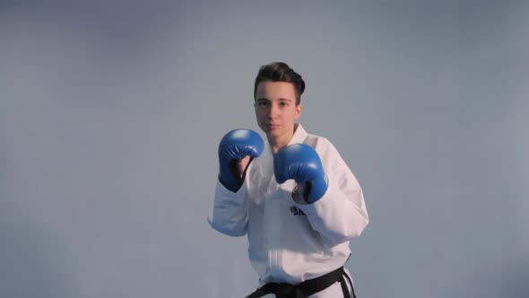 Woman Taekwondo Fighter Trains Shadow Boxing Punches and Kicks