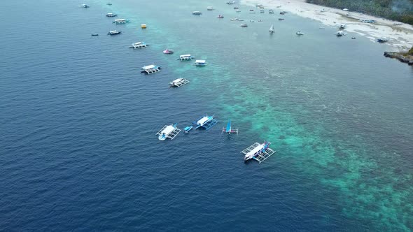 Traditional Boats Sailing In Moalboal Beach In The Philippines