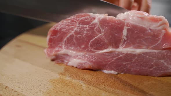 Chef Cutting the Meat on a Wooden Board