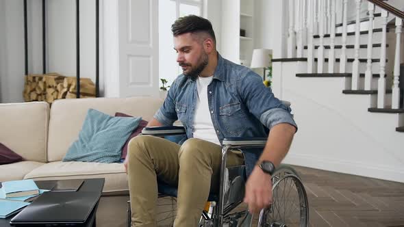 Young Bearded Man in Wheelchair Starting to Work from Home on Computer