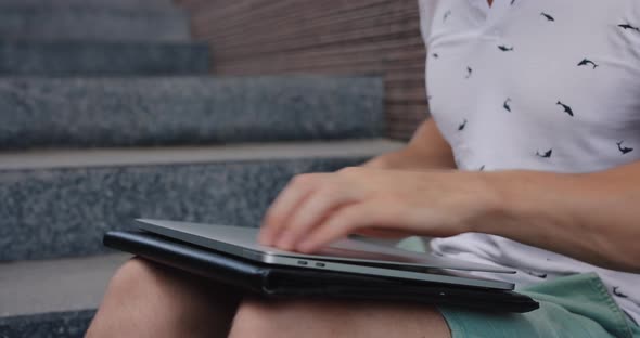 Male Hands Put the Laptop Into a Case