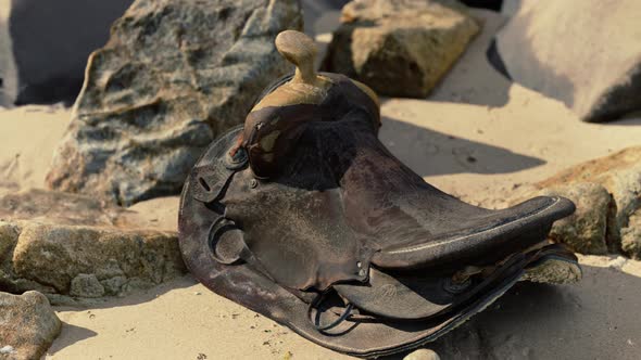 Very Old Horse Saddle on Sand Beach
