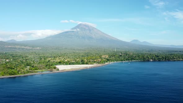 Fly Along Black Sand Beach with Volcano Mountains