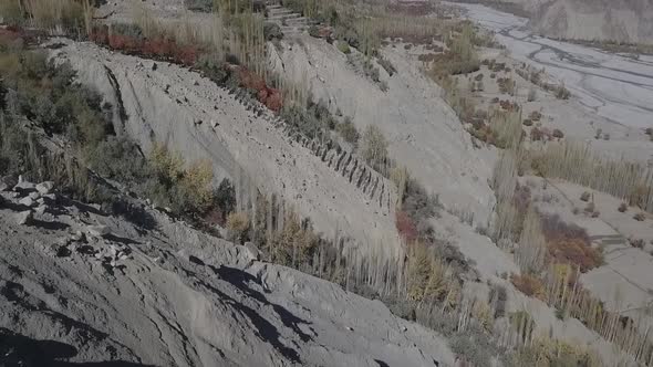 Aerial Over Gravel Rocky Hillside With Tilt Up Reveal Of Skardu Valley. Dolly Forward