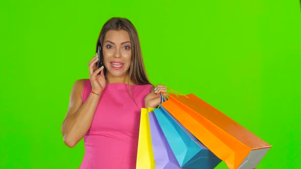 Woman with Shopping Bags Talking on the Phone, Green Screen Close Up