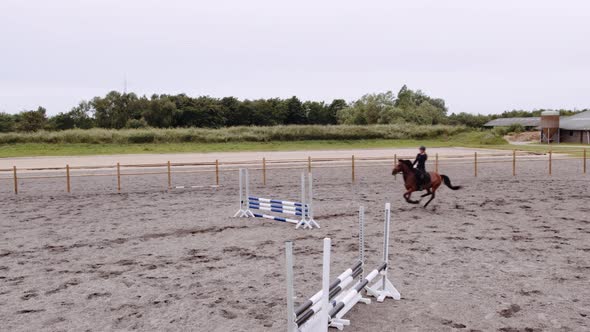 Drone Of Woman Horse Jumping Around Paddock