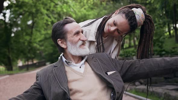 Woman with Dreadlocks Enjoying Leisure with Her Respected Positive Smiling Bearded Granddad
