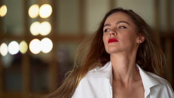 Portrait of a Young Woman with Red Lips and Hypnotic Eyes. Slow Movement of Flying Hair.