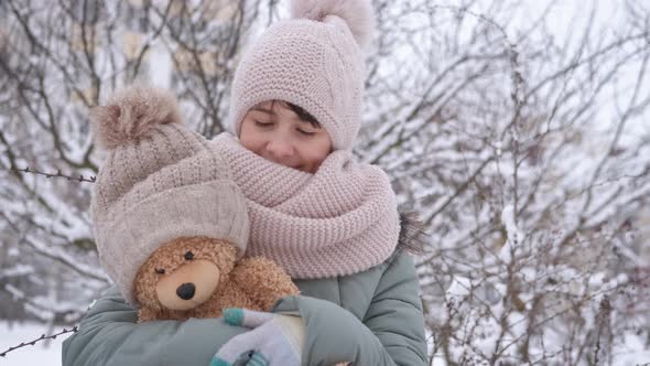 Hugging Teddy Bear in Winter