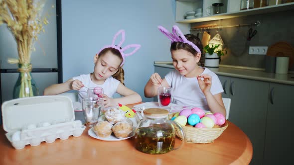 Little Girls Wearing Bunny Ears Painting Eggs on Easter Day