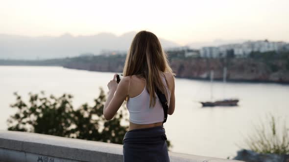 Woman Take a Photo of City Nature Panorama in the Dusk