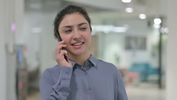 Portrait of Young Indian Woman Talking on Smartphone