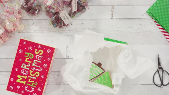 Flat lay. Step by step. Packaging homemade fudge and cookies into a Christmas gift box.