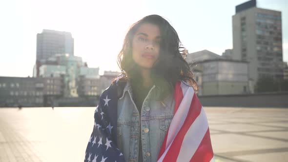 Proud African Woman Stand on Street Wrapped in Usa Flag Look at Camera Outdoor