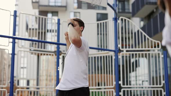 Sporty Handsome Coach with Moustache Showing to Schoolkids How to Warm Up Before Sport Class