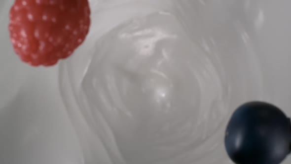 Fresh half sliced strawberries rain on yogurt in slow motion – Close up
