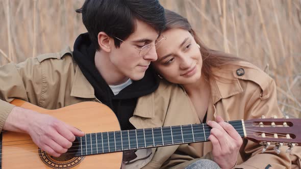 Portrait of Young Couple Having Date with Music Outdoors
