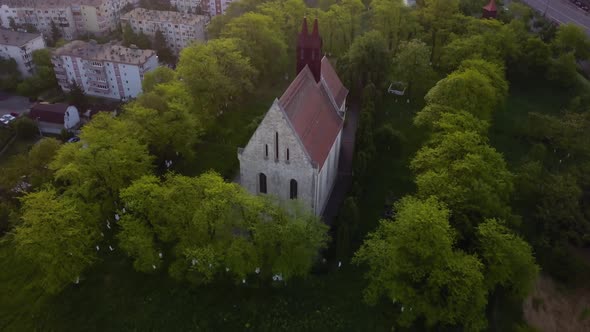 Round View Of Beautiful Church between trees forest And View of monument Town Cluj, Romania, Transyl alt