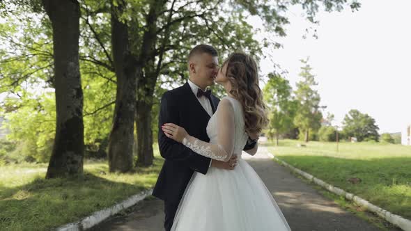 Caucasian Groom with Bride in the Park. Wedding Couple. Happy Family. Newlyweds